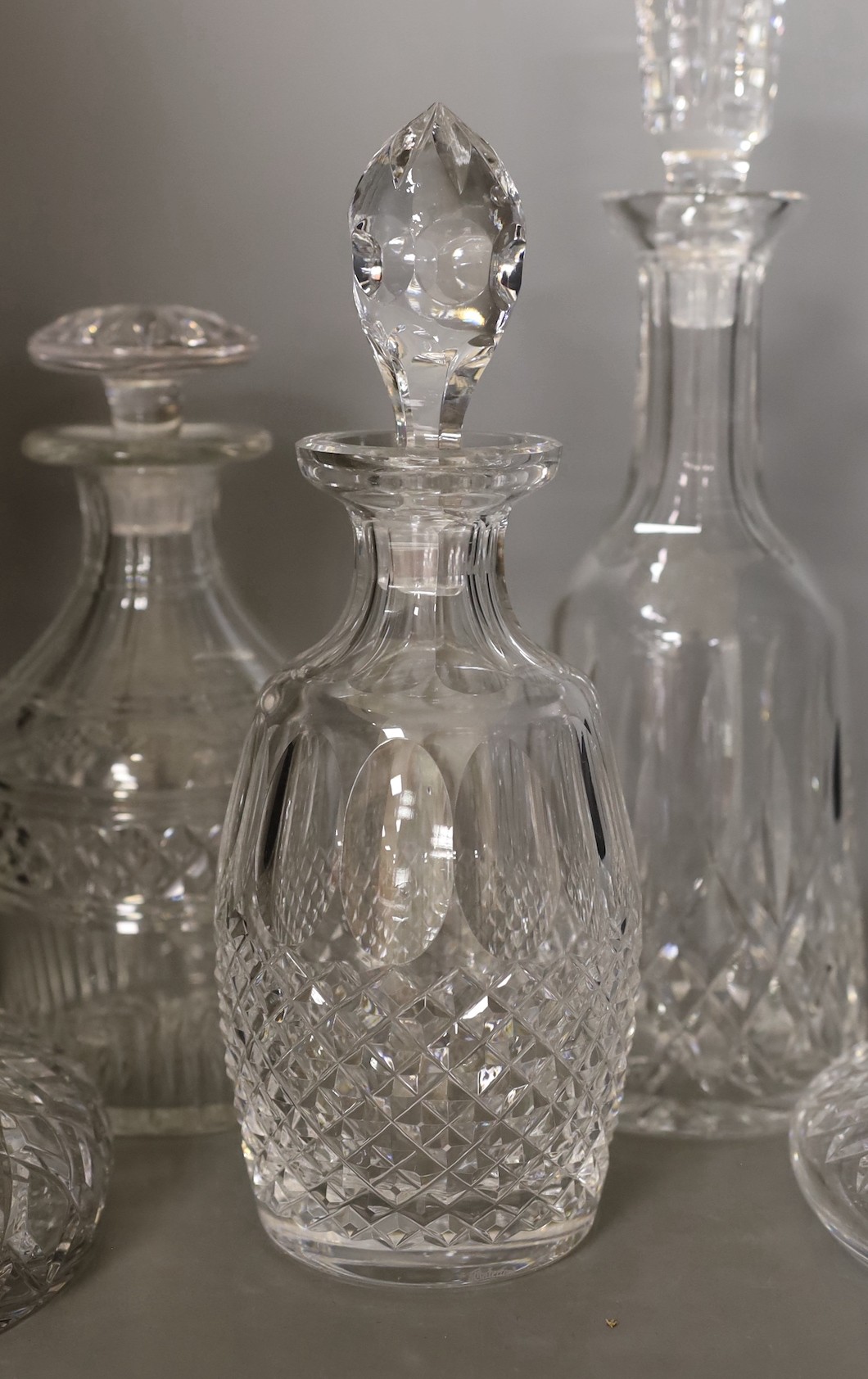 Two Waterford glass decanters, and three other decanters